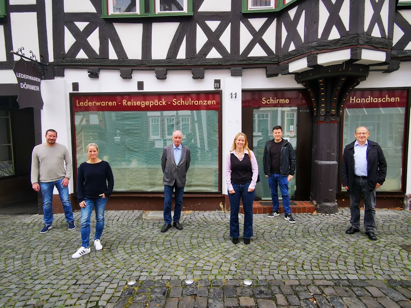 Foto von Florian Uhl, Susanne Pucher, Helmut Jachimsky, Jana Nathalie Burg, Dennis Pucher, Prof. Dr. Klaus Doll vor dem Licher Unternehmen "Lederwaren Dörmer"
